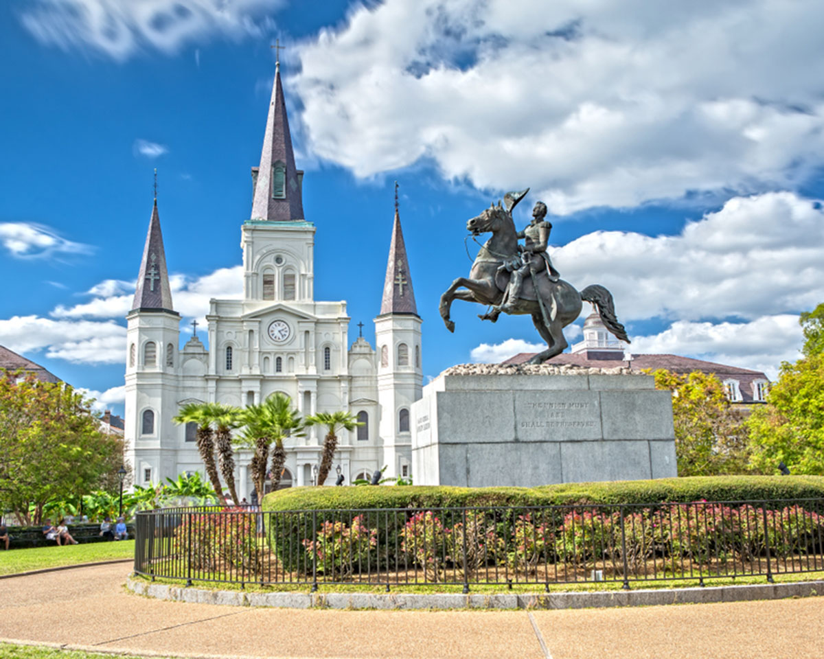 Equestrian statue in front of a cathedral.