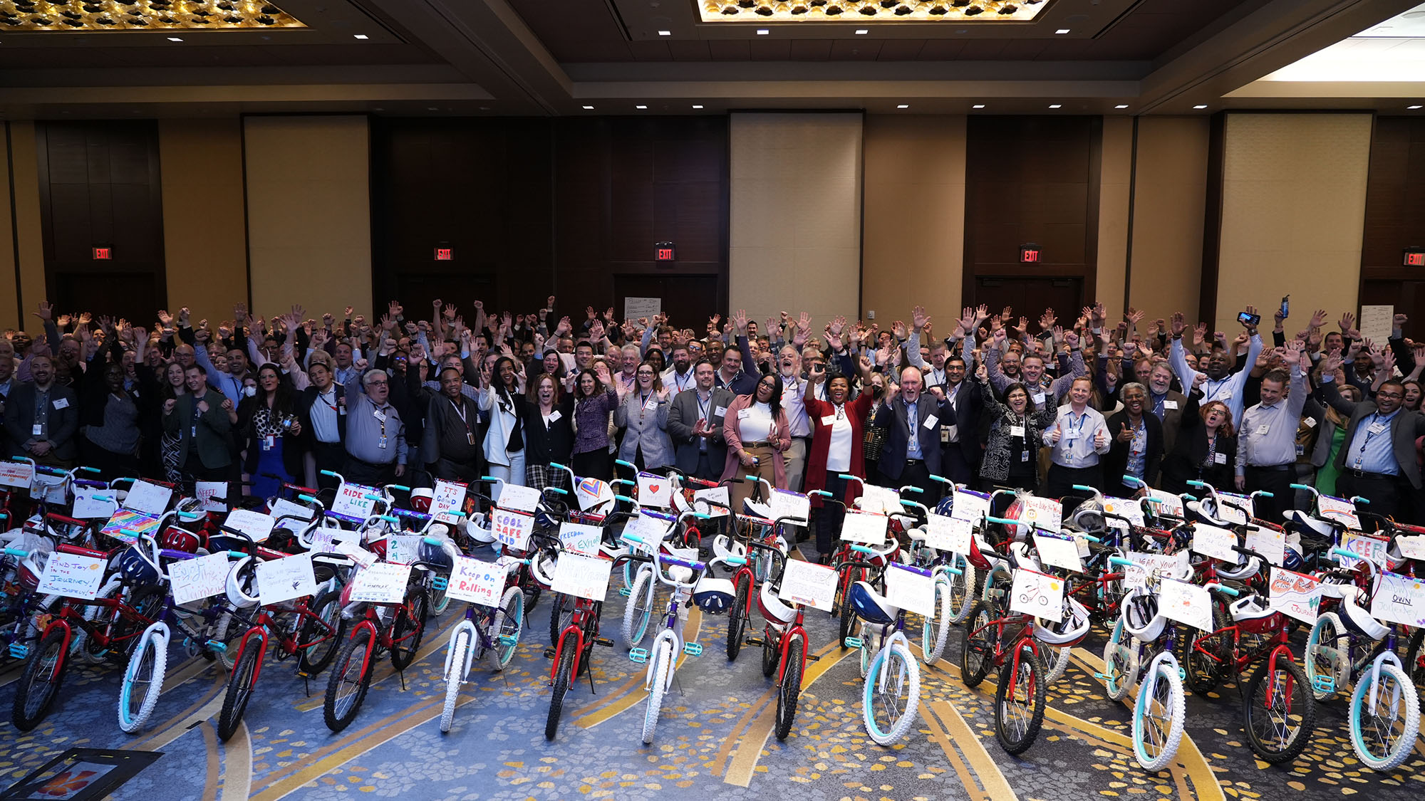 Amtrak employees stand behind newly assembled bikes for a community program. 
